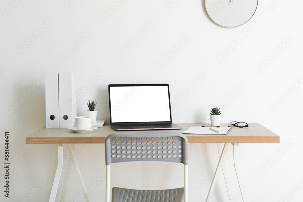 Workplace with modern laptop in the interior of the room Workplace with modern laptop in the interior of the room