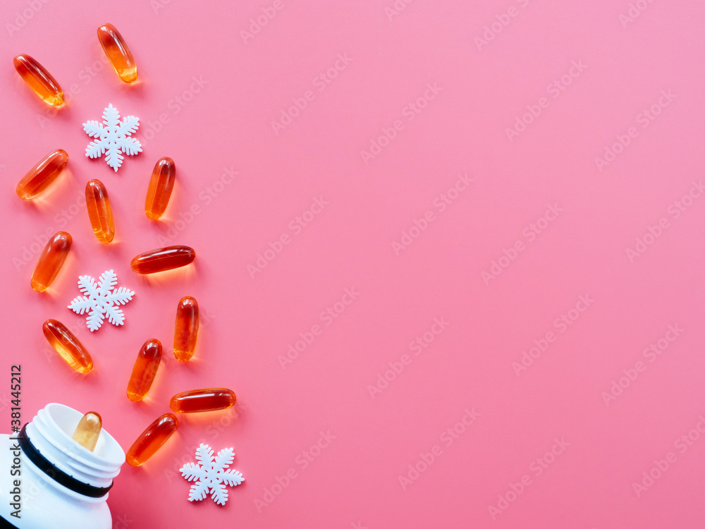 Jar with pills and Christmas decorations on a pink background, flat lay, copyspace. Christmas and new year concept of medicine and health care. Greeting card for a medical professional Jar with pills and Christmas decorations on a pink background, flat lay, copyspace. Christmas and new year concept of medicine and health care. Greeting card for a medical professional