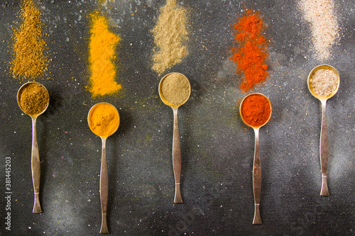 variation of spices on the vintage silver spoons, all spices on the table