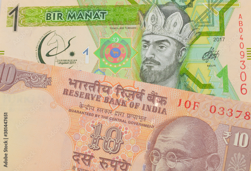 A macro image of a orange ten rupee bill from India paired up with a green and yellow one manat note from Turkmenistan.  Shot close up in macro.