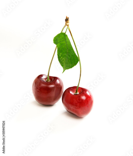 two cherries with leaf isolated on white background
