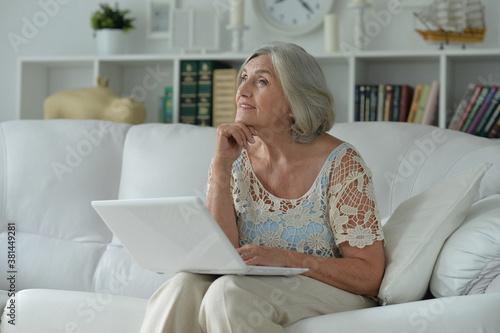 Portrait of beautiful senior woman with laptop