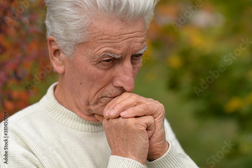 Close up portrait of thoughtful senior man outdoors