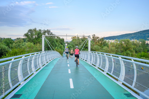 Bicycle riders riding on bicycle bridge (called “Freedom bridge”) connecting two countries Slovakia and Austria (Bratislava, SLOVAKIA)
