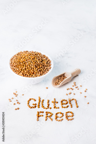 gluten free buckwheat is scattered on a gray background