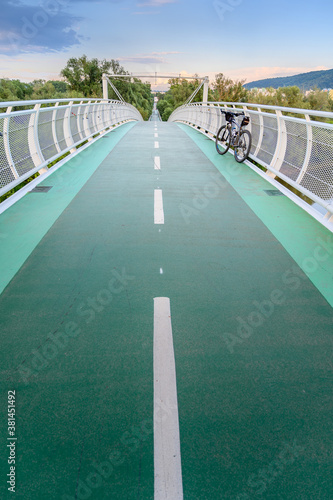 Empty bicycle bridge (called “Freedom bridge”) connecting two countries Slovakia and Austria during sunset (Bratislava, SLOVAKIA)