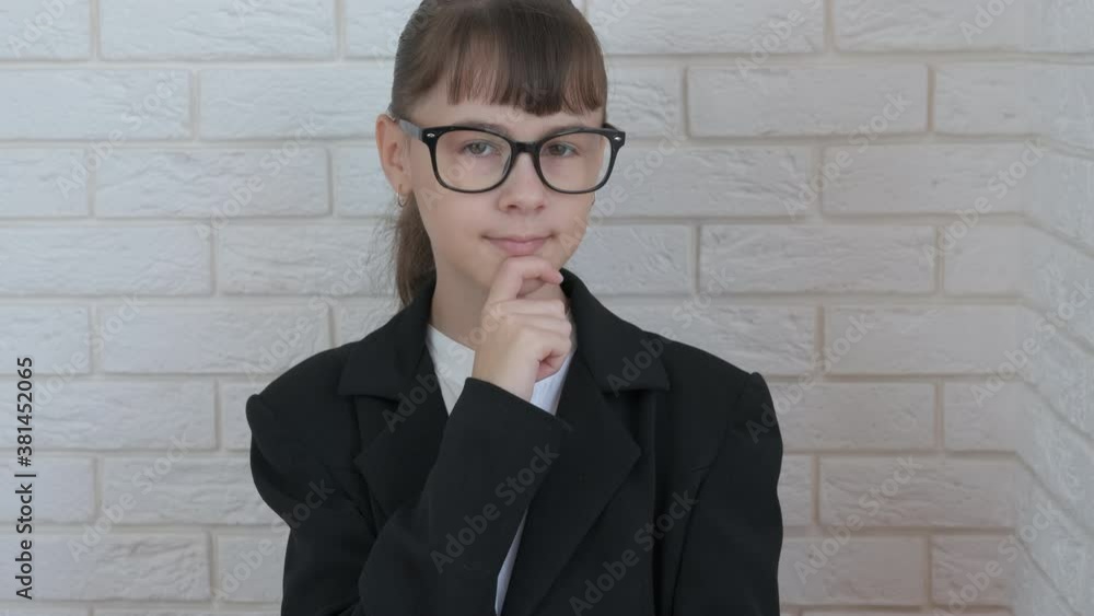 Young girl office employee in suit. A little girl in a suit thinking about her business. Young girl office employee in suit. A little girl in a suit thinking about her business.