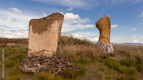 The close-up aicient megaliths i with sacred colored ribbons in the steppe of Khakassia. The Great Salabyk Kurgan. Valley of the Kings in Khakassia photo