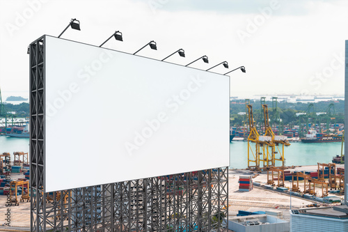 Blank white road billboard with Singapore cityscape background at day time. Street advertising poster, mock up, 3D rendering. Side view. The concept of marketing communication or sell idea.