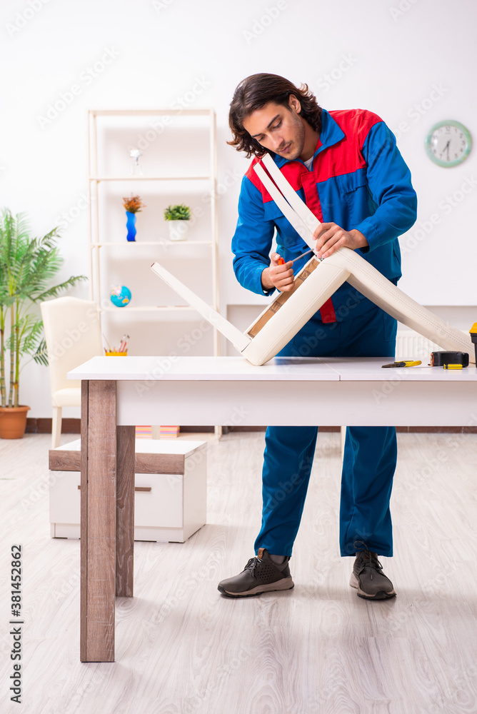 Young male carpenter working indoors Young male carpenter working indoors