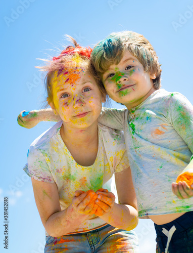 Portrait of happy little daughter and son on holi color festival.