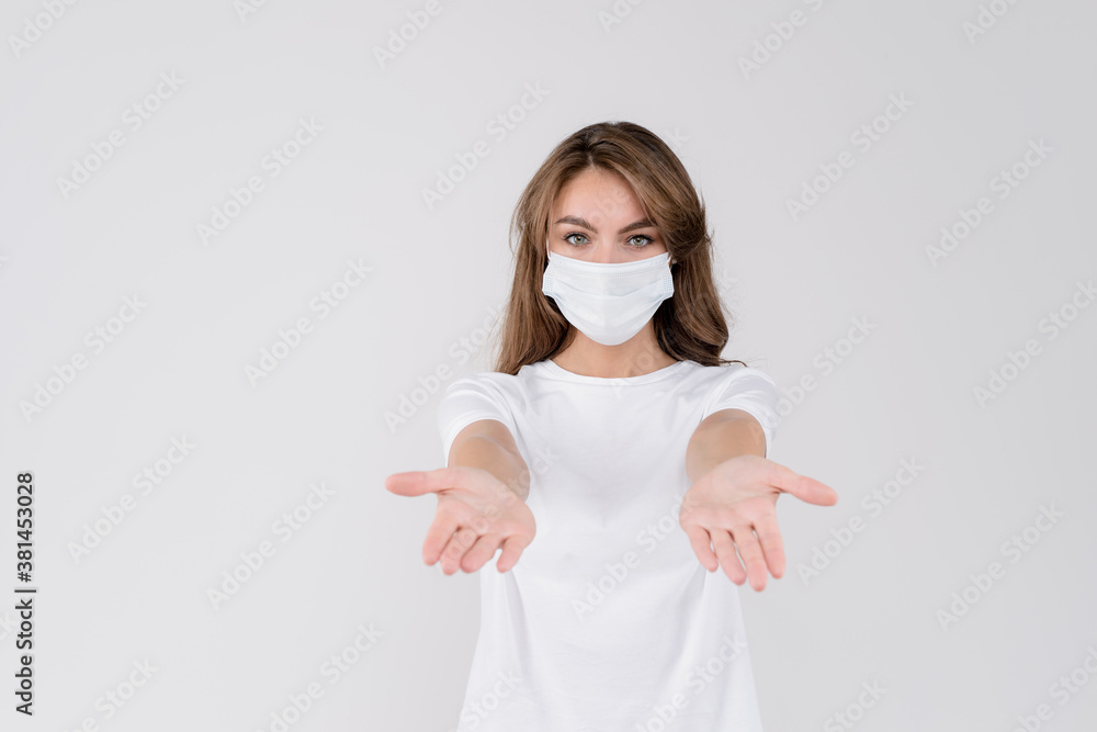 Image of serious woman wearing medical face mask putting palms forward isolated against white background Image of serious woman wearing medical face mask putting palms forward isolated against white background