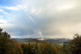 Rainbow in hills. Nature after rain. Wander in the wilderness.