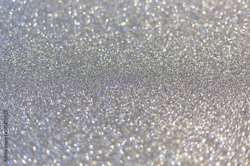 Silver abstract defocused bokeh background. Sparkling texture