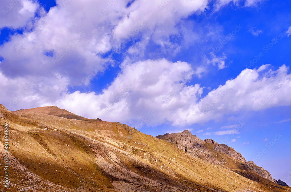 Epic mountain view with running dynamic clouds and mountains with chiaroscuro