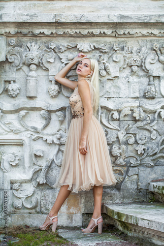 Young beautiful blonde girl in beige dress © Andrey_Arkusha