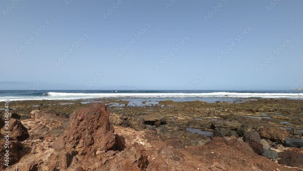 Fast movement view of summer beach with blue clear sky and nice weather - surf people in the waves - action extreme concept tourism and outdoor leisure activity Fast movement view of summer beach with blue clear sky and nice weather - surf people in the waves - action extreme concept tourism and outdoor leisure activity
