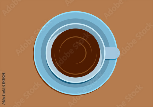 Taza de café azul en mesa marrón.
