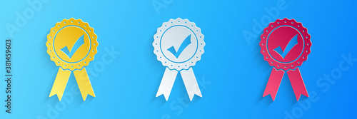 Paper cut Approved or certified medal with ribbons and check mark icon isolated on blue background. Paper art style. Vector.