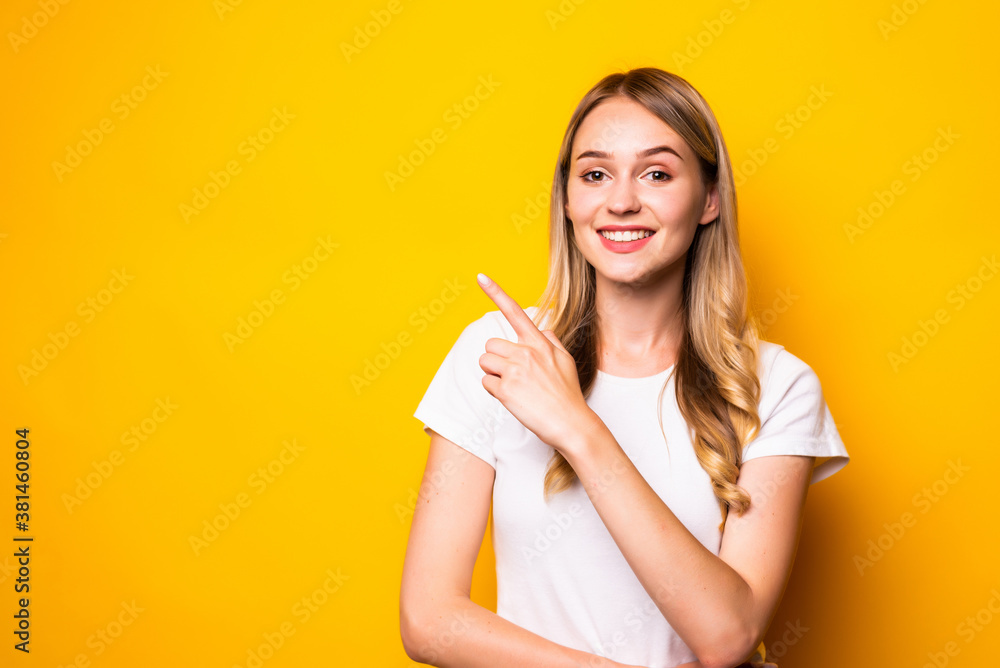 Young beauty woman pointed side isolated on yellow background Young beauty woman pointed side isolated on yellow background