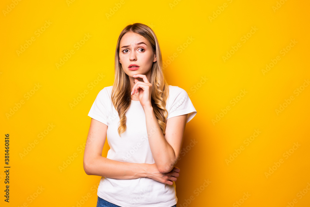Portrait of young woman think thoughts touch chin hands isolated over bright color background Portrait of young woman think thoughts touch chin hands isolated over bright color background