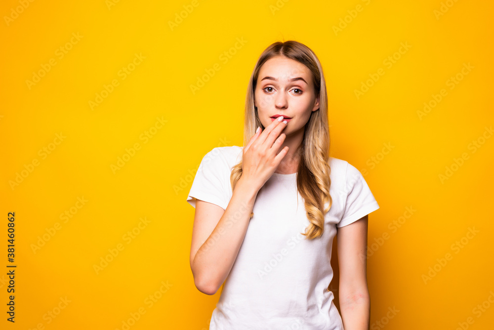 Shocked brunette woman with open mouth over yellow background Shocked brunette woman with open mouth over yellow background