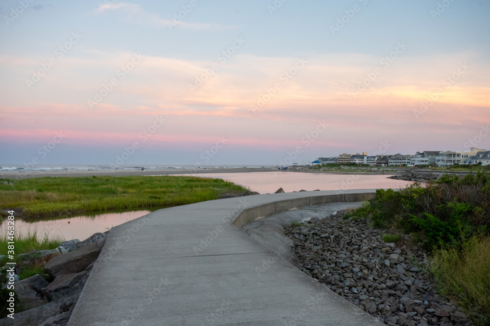A Concrete Path With an Orange and Blue Sunset Sky Behind It at the North Wildwood Sea Wall in New Jersey