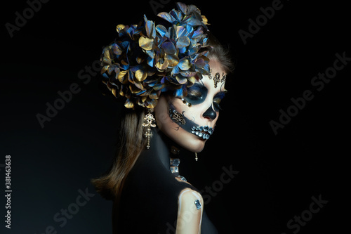 Halloween beauty portrait of a skeleton woman of death, the makeup on the face. Girl death Halloween costume. Day of The Dead. Charming and dangerous Calavera Catrina