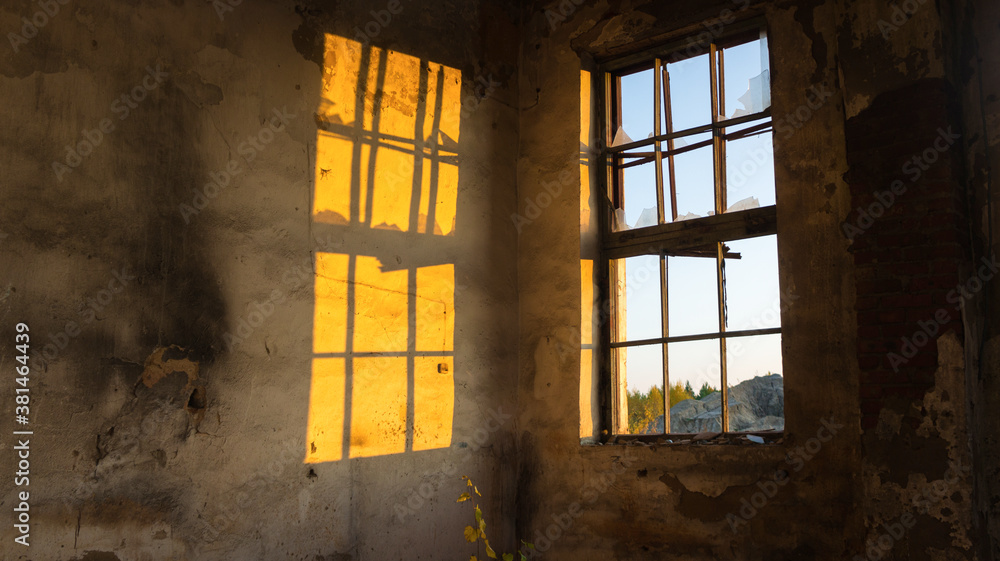 bright beautiful light is reflected on the wall through a broken window bright beautiful light is reflected on the wall through a broken window