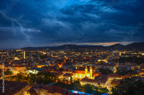Lightning storm with dramatic clouds over the city of Graz, with Mariahilfer church and historic buildings, in Styria region, Austria © Aron M  - Austria