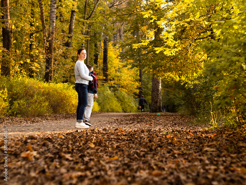 mom and son on a walk in the Park. the yellow foliage. autumn. mother's love for the child