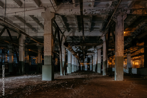 Dark creepy empty abandoned industrial building interior at night