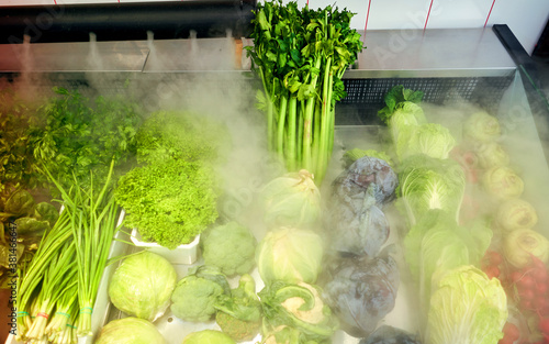 fresh vegetables are on display with a humidification system