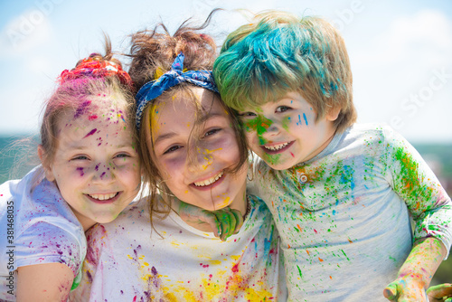 Kids celebrate holi with color, happy holi. Portrait of a happy laughing children.