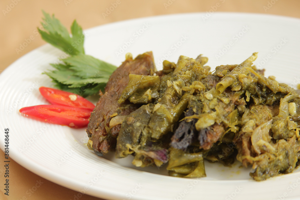Dendeng balado is a typical cuisine of West Sumatra made from thin and wide slices of beef that are dried and then fried dry. This fried meat is seasoned with green chilli Dendeng balado is a typical cuisine of West Sumatra made from thin and wide slices of beef that are dried and then fried dry. This fried meat is seasoned with green chilli