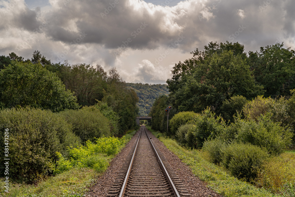 Fototapeta premium Railway in The Landscape with Grey Cloudy Sky