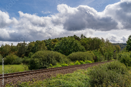 Railway in The Forest with Blue Cloudy Sky