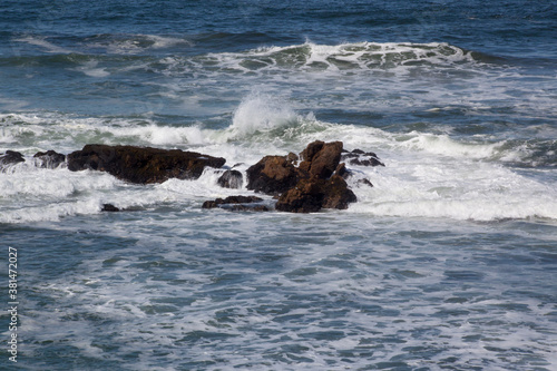 Ocean waves crashing onto rocks at the shore