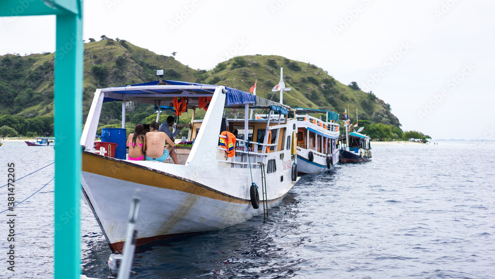 Naklejka premium Labuan Bajo, Indonesia - August 7, 2016: Tourist slow boat in Indonesia. Snorkeling and diving tours under water in Bali, Lombok and Flores. Adventure travel concept. Soft focus