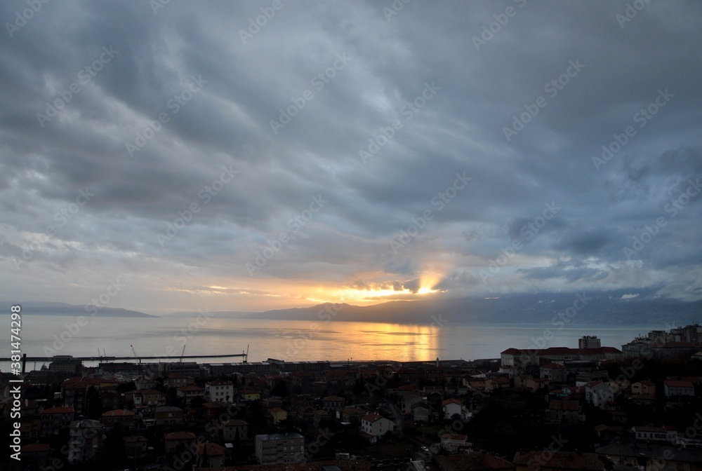 The sun s rays pierce the clouds and fall to the Adriatic Sea