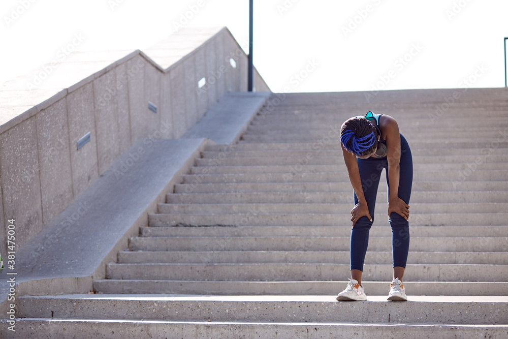 exhausted black fitness woman fizzle out, standing on stairs outdoors. after running exhausted black fitness woman fizzle out, standing on stairs outdoors. after running