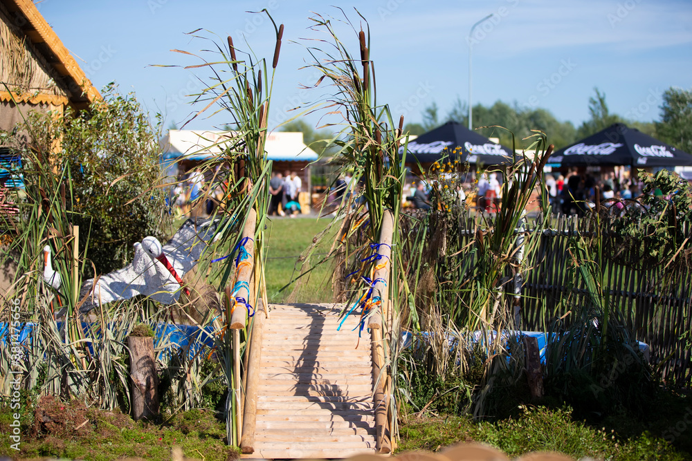 Fototapeta premium Rustic background of the house and fence, as well as a bridge decorated with herbs.