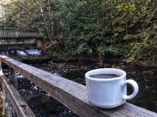 cup of coffee by the beautiful river