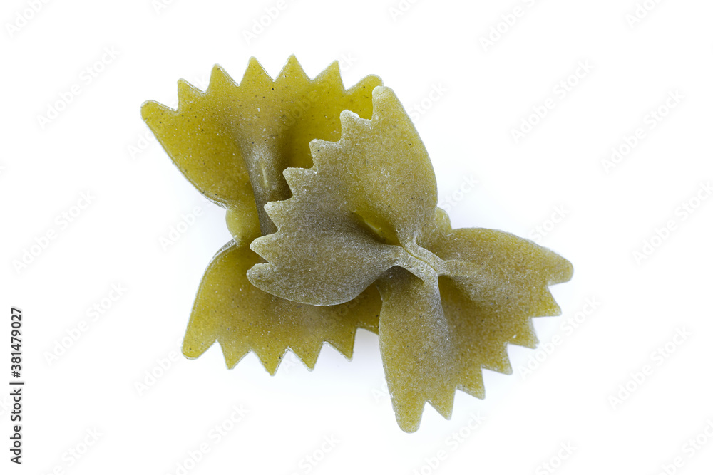 Color Farfalle - dry pasta isolated on a white background. A variety of types and forms of Italian pasta. Close-up. Color Farfalle - dry pasta isolated on a white background. A variety of types and forms of Italian pasta. Close-up.