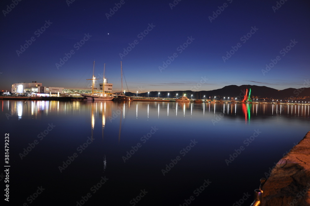 Night view of the port in Rijeka city, Croatia. Rijeka city of culture 2020 night lights of the harbour, wiev from the sea. Night scene in the city of Rijeka, harbour in Croatia