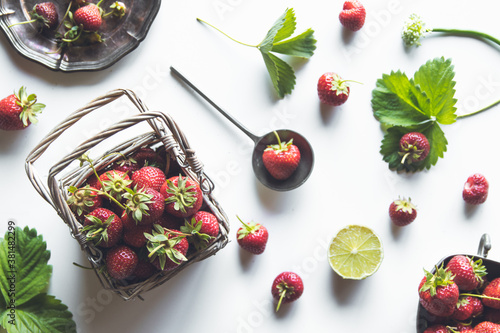 fresh strawberries in a basket on a white wooden table photo