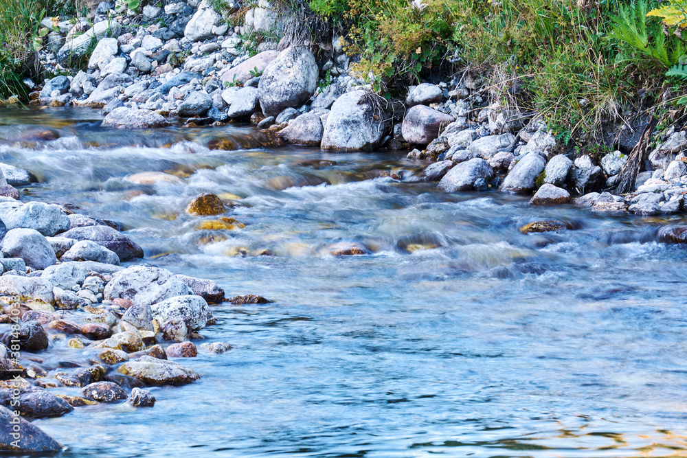 clean mountain stream in rocky shores blurred in motion clean mountain stream in rocky shores blurred in motion