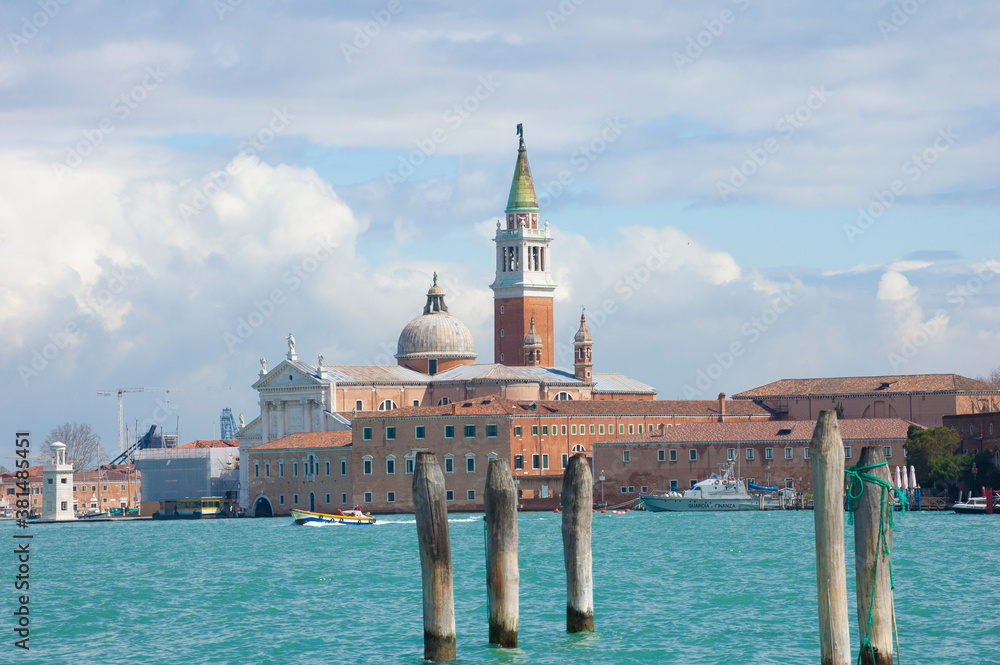 Fototapeta premium Venice, Basil. of San Marco and the tower bell from la Gudecca, island traditional venetian offshore boat, sunny day