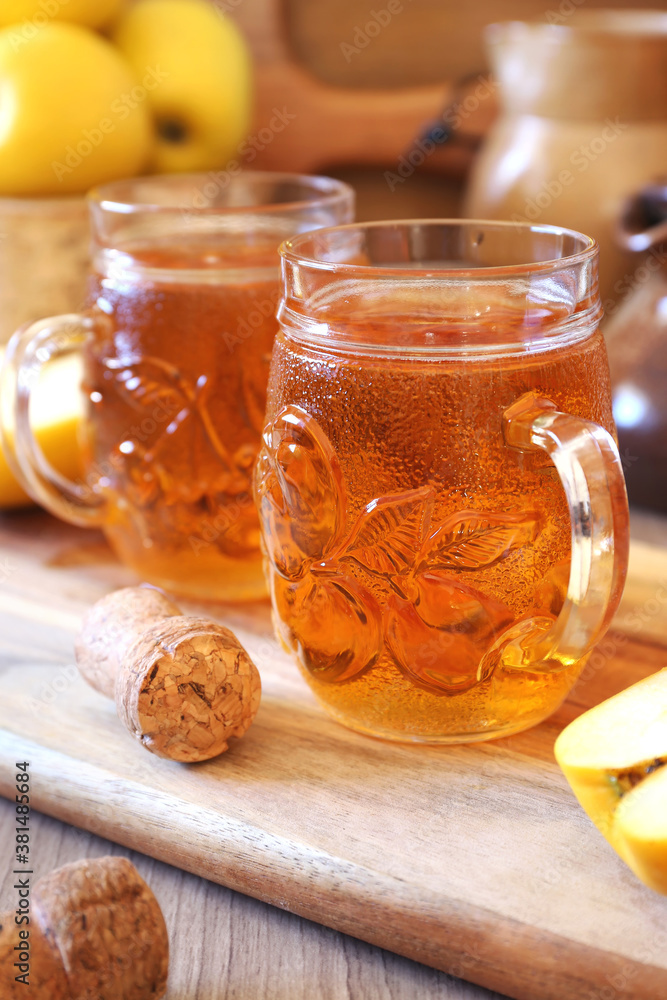Two cups of Apple Cider, yellow apples and ceramic pitcher Two cups of Apple Cider, yellow apples and ceramic pitcher