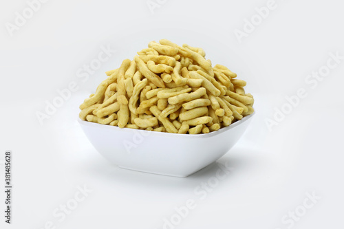 Indian snacks gathiya in white bowl in white background.